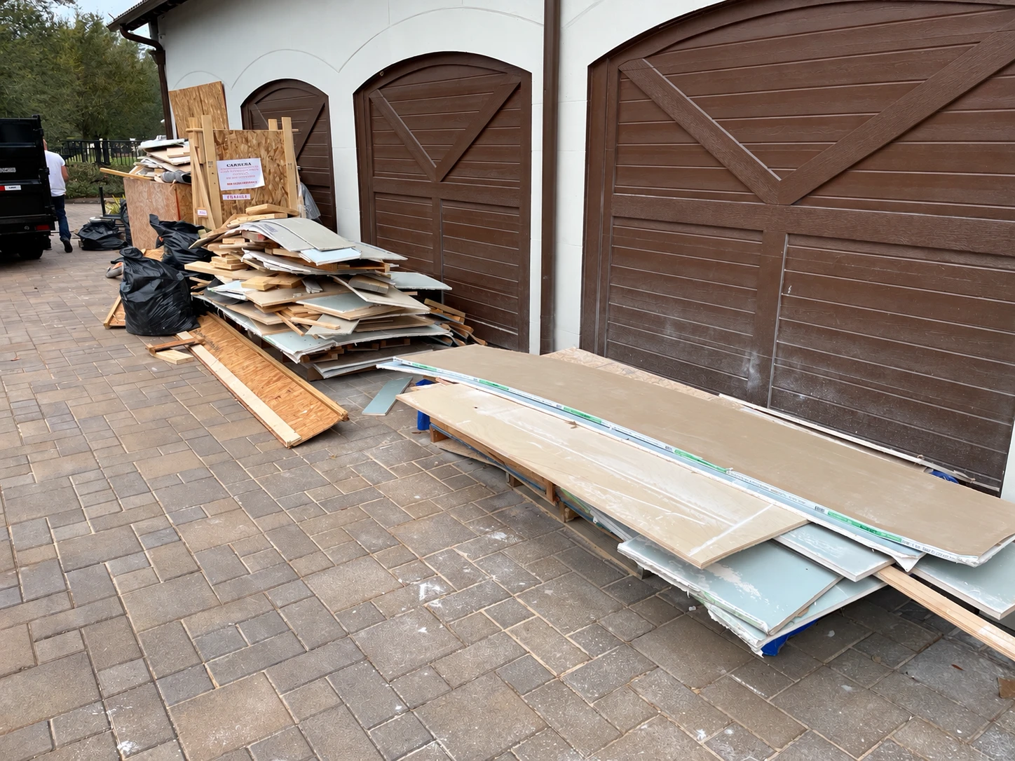 Renovation debris ready for removal from a driveway